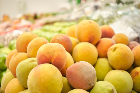 Stack of peaches in a fruit store. Bright image with copy space.の写真素材