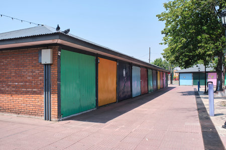 Tigre, Buenos Aires, Argentina, Jan 11 2022: Puerto de Frutos, Port of Fruits, handicraft market premises closed. Blinds of different colors on a sunny morning.のeditorial素材