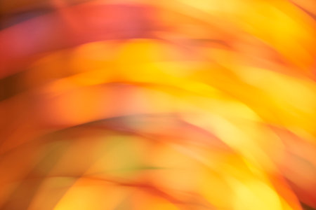 Abstract blurred background, dynamic lights in motion, flowing design in warm orange and yellow vibrant colors.の写真素材