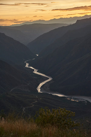 Chicamocha river flows through a large canyon, mountainous Andean scenery in Santander, Colombia, at sunset.の写真素材