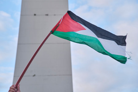 Buenos Aires, Argentina, Feb 16, 2024: Palestinian flag waving in front of the obelisk, in downtown, during a demonstration in solidarity with Palestine and against Israel attack and zionist genocide.のeditorial素材