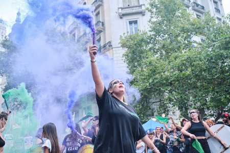 Buenos Aires, Argentina; March 8, 2024: women raising violet and green smoke flares in the air during the 8M international women strike.のeditorial素材
