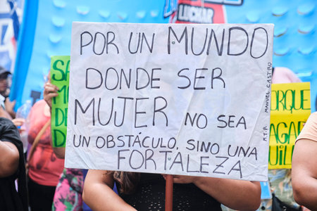 Buenos Aires, Argentina; March 8, 2024: International feminist strike. Woman holding a poster: For a world where being a woman is not an obstacle, but a strength.のeditorial素材