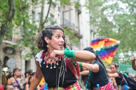 Buenos Aires, Argentina; March 8, 2024: Women wearing colorful traditional textiles and waving the...
