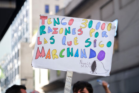 Buenos Aires, Argentina; March 24, 2024: Poster in memory of the victims of the dictatorship, with a white scarf and a text in colorful letters: I have 30,000 reasons why I keep marching. Never again.のeditorial素材