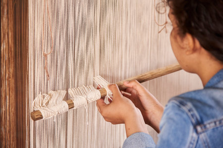 Barichara, Santander, Colombia; November 25, 2022: Young woman learning the traditional art of loom...