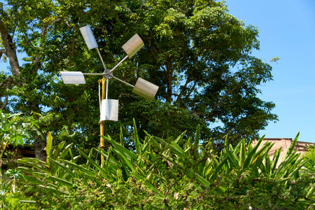Windmill in a rural tropical setting. Concept: renewable energy generation. Composition with copy...