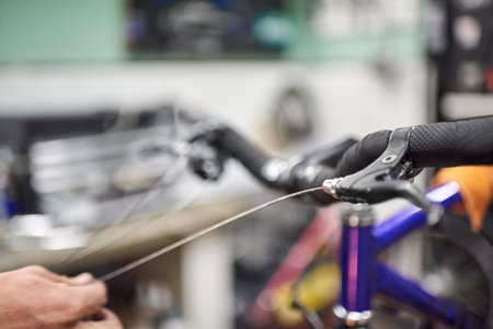 Unrecognizable repairman assembling the brake system of a bicycle as part of the maintenance service...