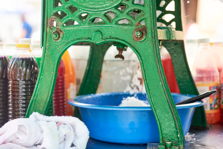 Process of making a raspado, a refreshing traditional dessert as street food in Colombia composed of crushed ice with different sweet flavors and sauces or toppings.の写真素材