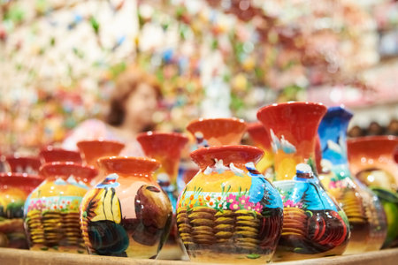 Sale of handmade ceramic vases painted with colorful traditional scenes, in Raquira, Colombia, town known for its handicrafts and pottery.の写真素材