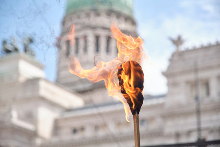 February 11, 2026; Buenos Aires, Argentina: massive protest against labor reform being debated that same day in the Senate. A lit torch in the foreground, the National Congress in the background.のeditorial素材