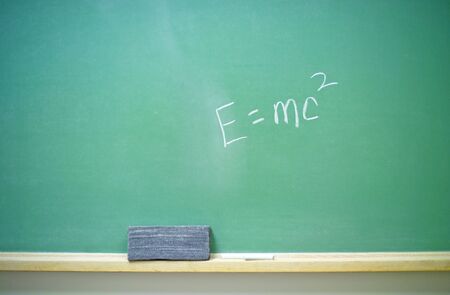 A horizontal green chalkboard with Albert Einstein's E=mc2 equation. 14MP camera.の写真素材