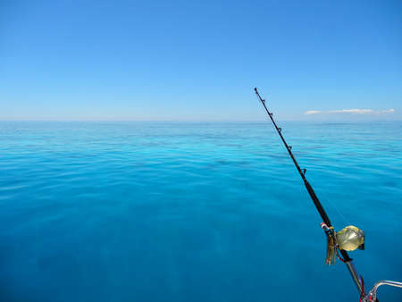 Fishing on a Blue Lagoon with Coral Reef, New Caledoniaの写真素材
