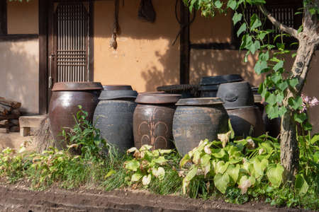 Kimchi jars in front of Korean Traditional House
