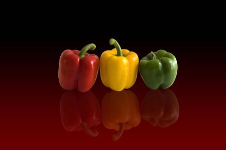 Three peppers in arow on red backgroundの写真素材