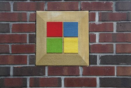 Brick wall with red, yellow, blue and green insertsの写真素材