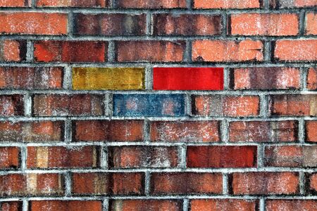 Brick wall with red, green and yellow colorsの写真素材