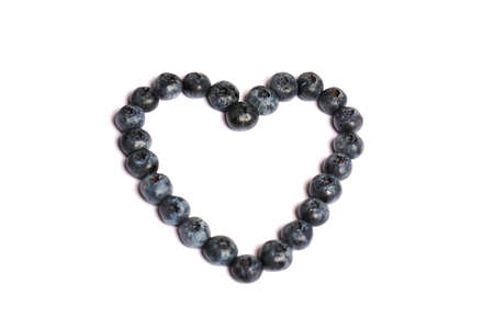 blueberries in the shape of a heart isolated on whiteの写真素材