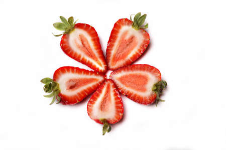Cut strawberries in the shape of a flower isolated on whiteの写真素材