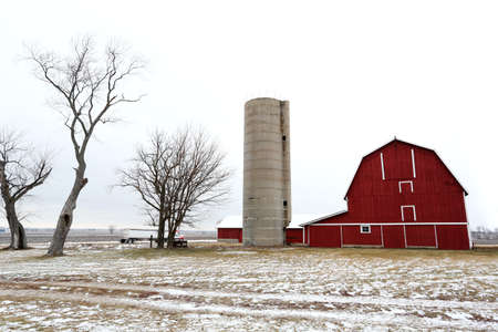 And old red barn and silo in winter in Illinois