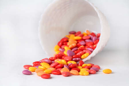 Valentines Day heart candy spilling out of white bowlの写真素材