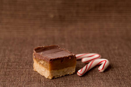 Single home made caramel treat bar with candy canes for Christmasの写真素材