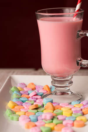strawberry milk and conversation hearts for Valentines Day close up