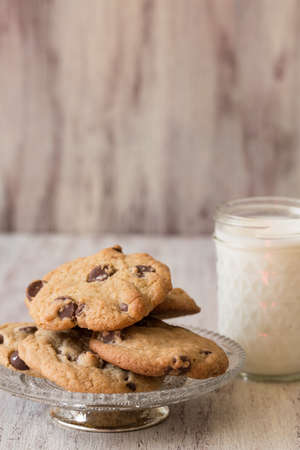 cookies on an antique plate with a glass of milk