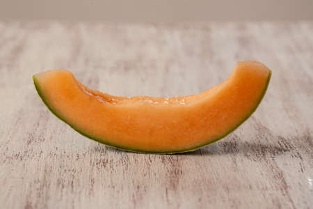 Slice of cantaloupe from the side to look like a smileの写真素材
