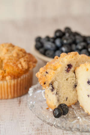 Blueberry muffin breakfast scene with bowl of blueberries in the backgroundの写真素材