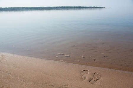 Footprints in the sand of beach on Lake Michigan shore horizontalの写真素材