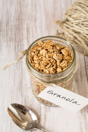 Almond breakfast granola in glass jar with tagの写真素材