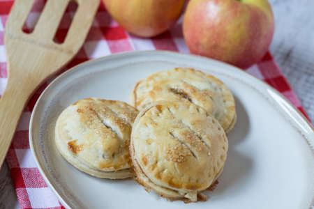 small apple hand pies on red checkered napkinの写真素材