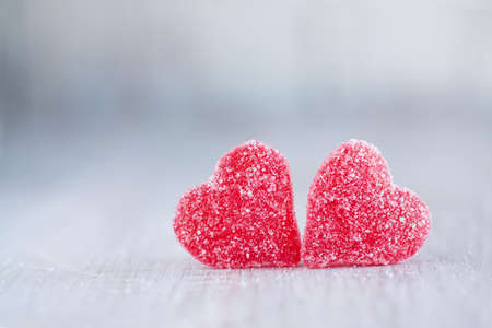 Two red Valentines Day candy hearts next to each otherの写真素材