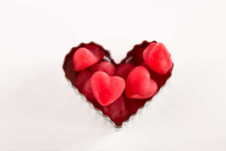 Valentines Day red heart candies in cookie cutterの写真素材