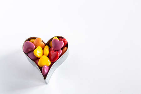 Valentines Day multi colored candies in heart shaped cookie cutterの写真素材