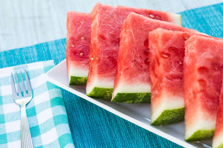 Juicy delicious watermelon summertime snack on a plate with fork