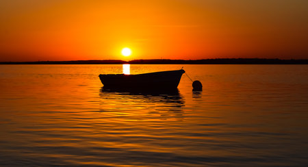 Boat in the sea with beautiful sunsetの写真素材