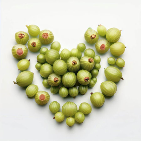 Fresh green gooseberries in the shape of a heart on a white backgroundの素材