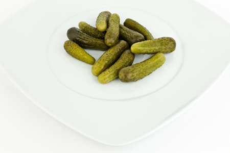 Pickled cucumbers in dish on white background.の写真素材