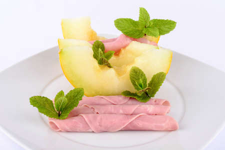Ham and melon on white background.の写真素材