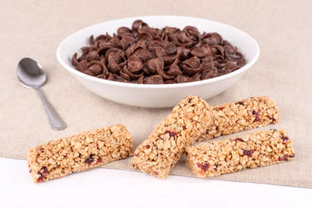 Dish with chocolate cereal flakes and bars with red  fruits.の写真素材