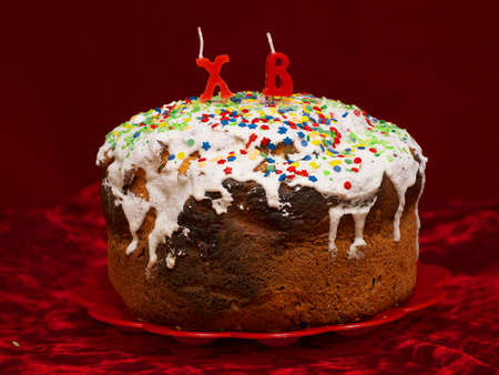 Easter cake with candle on dark background, morning after easterの写真素材