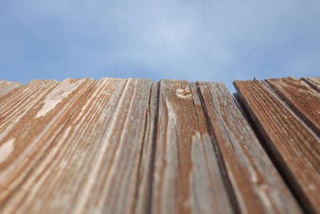 Red old wood textured background with blue sky.の写真素材