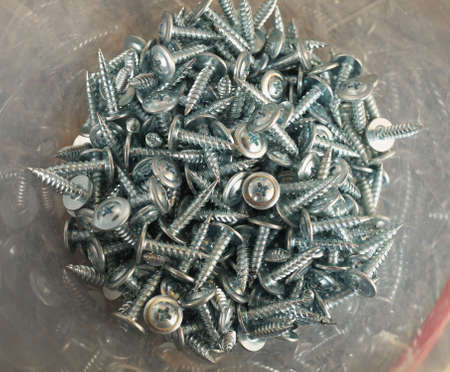 tapping screws made od steel, metal screw, iron screw, chrome screw, screws as a background, wood...