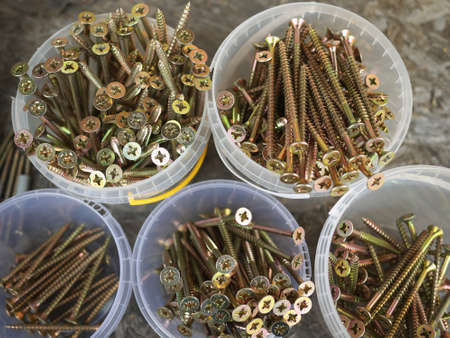 set of Gold screws plastic boxes on the construction site.の写真素材