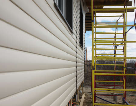 repaired rural house, fixed facade, waterproofing wood house by the vinyl plasting siding.の写真素材