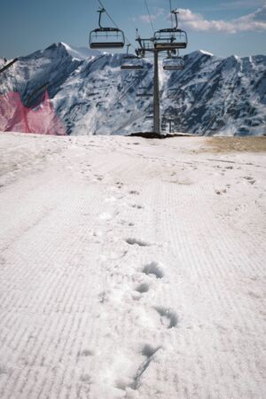 Gondola lift and snow ski slope at sunny day the mountain. Caucasus Mountains, Georgia, region...