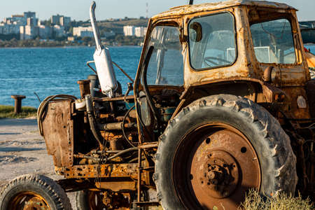 Old rusty abandoned tractor in Crimea. Against the background of the Sea of Azovの写真素材