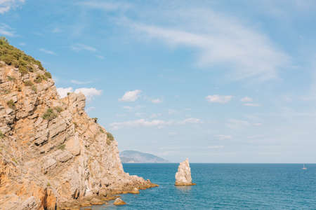 Crimea. Rock Sail in the sea on the background of the southern coast on a sunny day.